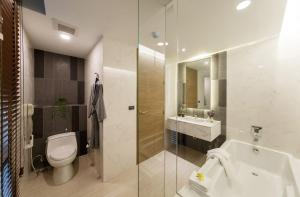 a bathroom with a toilet and a sink and a shower at LiT BANGKOK Residence in Bangkok +92 photos