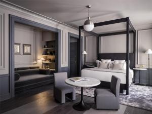 a bedroom with a bed and a table and a couch at The Bellevue Hotel, in the Unbound Collection by Hyatt in Philadelphia
