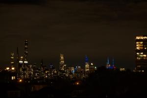 a city skyline at night with blue lights at Big apple room 33 in West New York