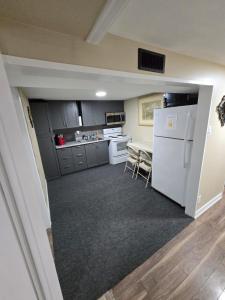 a kitchen with a white refrigerator and a table at Bright Room in Walkout Basement in Pickering