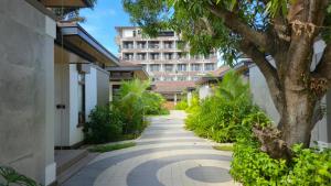 a walkway with a tree and a building at Brio de Agoho in Candelaria