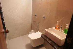 a bathroom with a toilet and a sink at South Forest Wayanad By Bestinn Leisure in Sultan Bathery