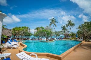a pool at a resort with white chairs and palm trees at Crystal Bay Yacht Club Beach Resort in Lamai