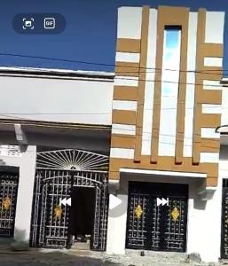 a building with black and white doors and windows at Al-Ahmari Holiday Apartment in Mogadishu +2 photos