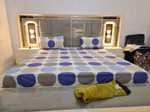 a bedroom with a large bed with blue and white at Al-Ahmari Holiday Apartment in Mogadishu