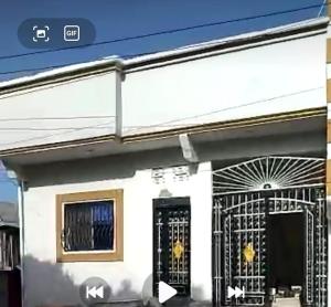 a house with a gate in front of it at Al-Ahmari Holiday Apartment in Mogadishu