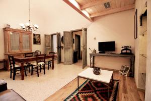 a living room with a table and a dining room at Osterio Magno in Cefalù
