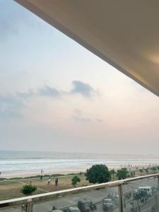 a view of a beach with people and the ocean at REEF VIEW Beach Hotel in Matara