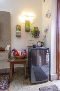 a kitchen with a table and a dishwasher in a room at Matrika Stays in Lucknow
