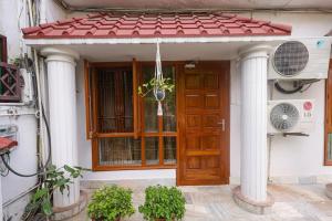 a house with a wooden door and a window at Matrika Stays in Lucknow +5 photos