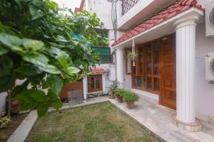 a front door of a house with a yard at Matrika Stays in Lucknow