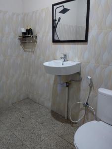 a bathroom with a sink and a toilet at Traveling Guest House - Shared Kitchen in Kuta Lombok