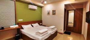 a bedroom with a bed with towels on it at MALAPPURAM RESIDENCY in Malappuram