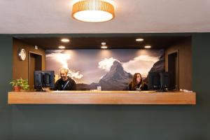 a tv screen with a picture of a mountain at Zermatt Youth Hostel in Zermatt