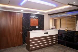 an office with a reception desk with a sign on the wall at Hotel Koyla Boarding and Lodging in Chikmagalūr