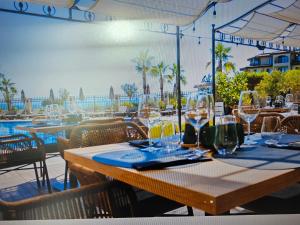 a table with wine glasses on top of a restaurant at Zerini Apartment in Burgas