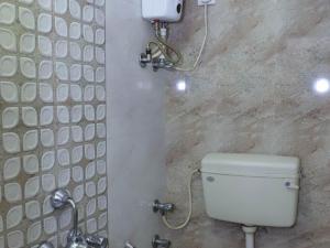a bathroom with a toilet and a shower at Shree Residency in Airoli