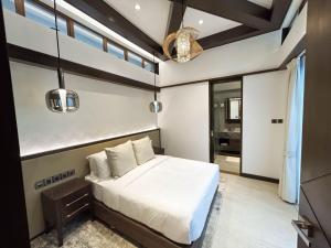 a bedroom with a bed in a room with windows at Brio de Agoho in Candelaria +34 photos