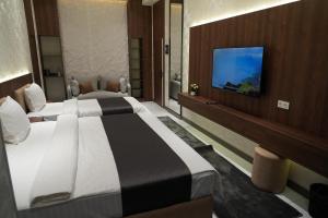 a hotel room with a bed and a flat screen tv at NINETY boutique hotel in Yakkasaray