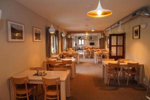 a restaurant with tables and chairs in a room at Wellness hotel Sauna in Malá Morávka