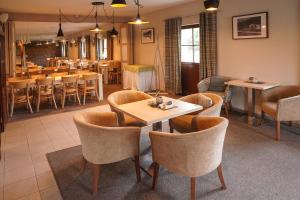 a restaurant with tables and chairs and a dining room at Wellness hotel Sauna in Malá Morávka