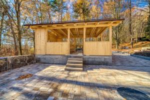 a wooden pavilion in a park with trees at Vila SIGORD in Kokošovce