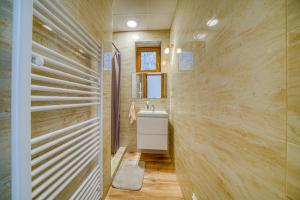 a bathroom with a sink and a mirror at Vila SIGORD in Kokošovce +7 photos
