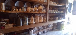 a shelf filled with lots of vases and plates at Maharaja palace houseboat in Srinagar +61 photos