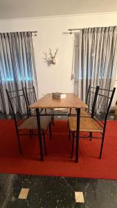 ein Holztisch und zwei Stühle sowie ein Tisch und Stühle in der Unterkunft Pasithea's Apartment in Samos + 4 Fotos