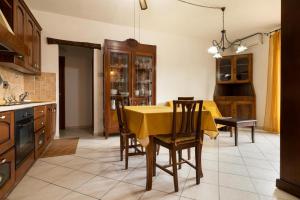 a kitchen with a table with a yellow table cloth on it at Casa AnnaMarea in San Vincenzo