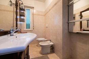 a bathroom with a sink and a toilet at Casa AnnaMarea in San Vincenzo +54 photos