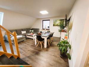 a living room with a couch and a table at FeWo Igelnest ID 16292-0 in Kargow +17 photos