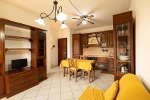 a kitchen and dining room with a yellow table at Casa AnnaMarea in San Vincenzo