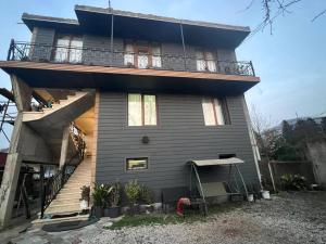 a house with a balcony on the side of it at Family Hotel in Batumi