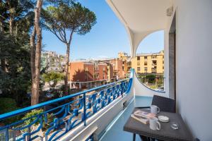 a balcony with a table and a view of a city at The Reef Sorrento in Sorrento