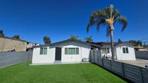 a white house with a palm tree in a yard at Gillespie Dr 2BR 1BA Unit A | Near Downtown SD in Spring Valley