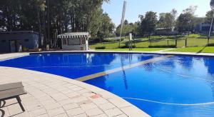 a blue swimming pool with a bench next to it at Eye with a view in Eikenhof