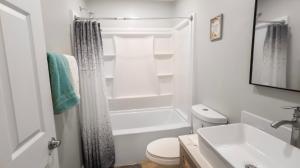 a white bathroom with a toilet and a sink at Gillespie Dr 2BR 1BA Unit A | Near Downtown SD in Spring Valley +38 photos