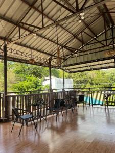 a group of tables and chairs in a pavilion at Sonora's Inn, Coron in Coron