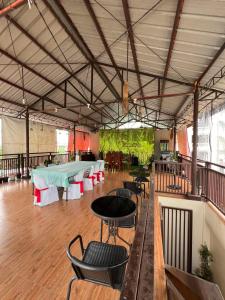 a large room with tables and chairs in it at Sonora's Inn, Coron in Coron