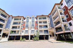 a large apartment building with a lot of windows at GoldKent Kileleshwa in Gatunga