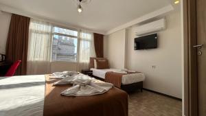 a hotel room with two beds and a tv at HOTEL GLOBAL 2022 in Istanbul +134 photos