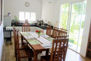 a kitchen with a wooden table with chairs and a dining room at Tailors Cottage in Hatton
