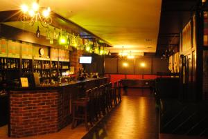 a bar in a restaurant with a brick wall at Hotel Restaurant Complex Roman'S in Vishenki