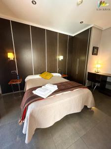 a hotel room with a bed with towels on it at HS Alcalá in Alcalá del Júcar +10 photos