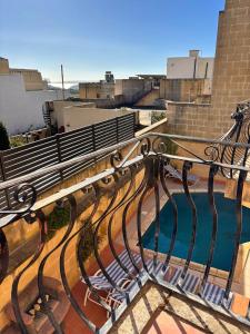 a bench sitting on top of a building at Ta Carmen Farmhouse with pool in Qala