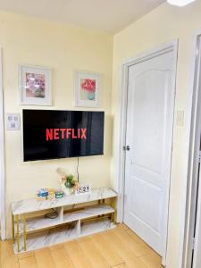 a white door in a room with a sign on the wall at Your Comfort Zone Staycation1 in Manila