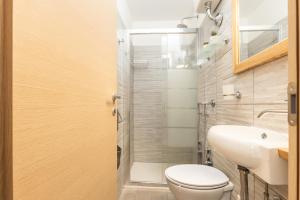 a bathroom with a toilet and a sink and a shower at Climbing House in Baunei +24 photos