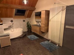 a bathroom with a tub and a sink and a shower at B&B Oase in Londerzeel +12 photos