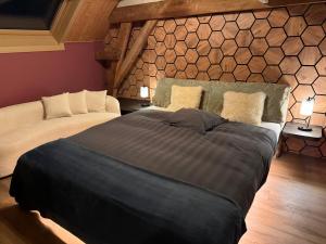 a bedroom with two beds and a stone wall at B&B Oase in Londerzeel